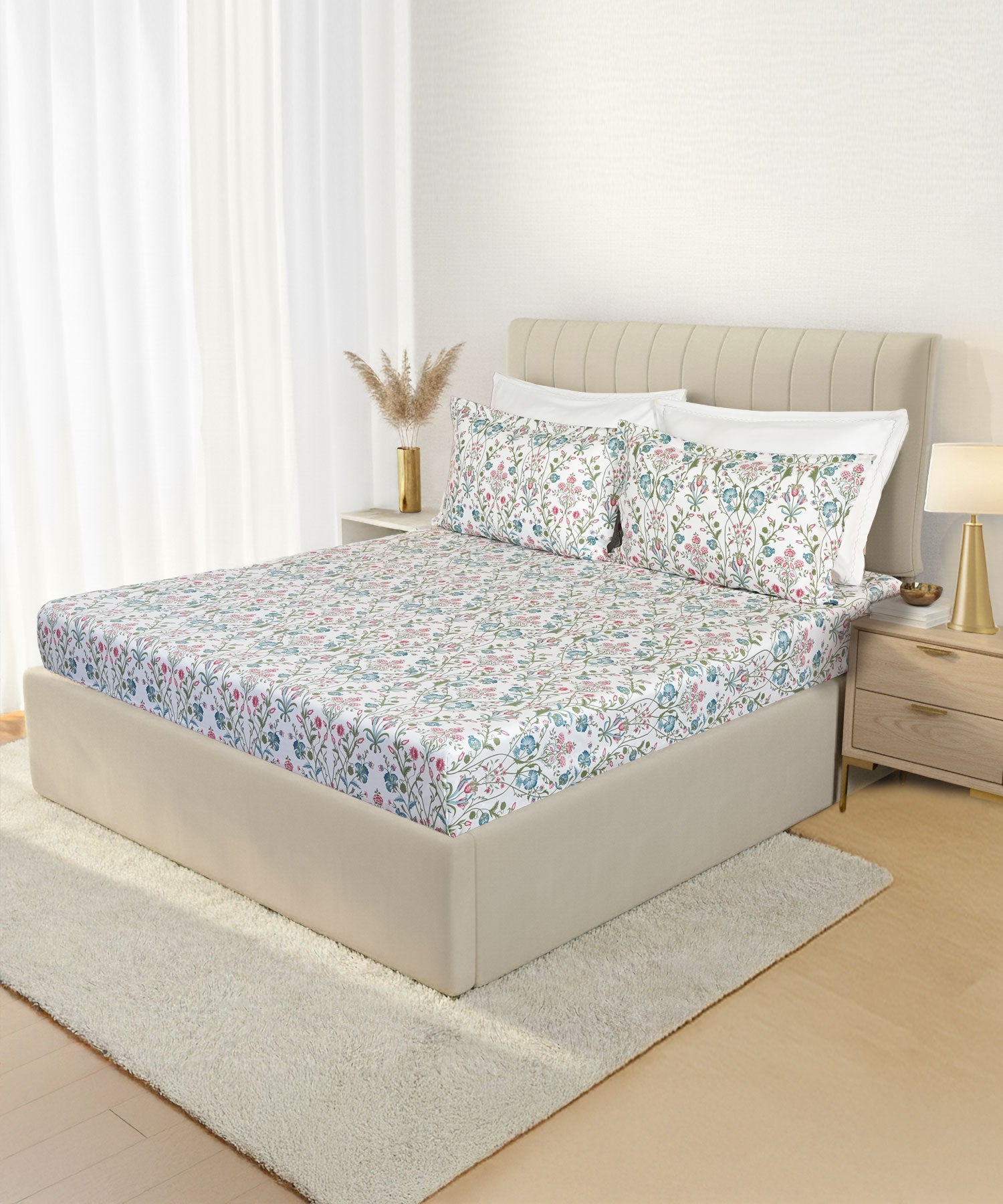 Bedroom with a botanical-print bedsheet, warm neutral walls and rug
